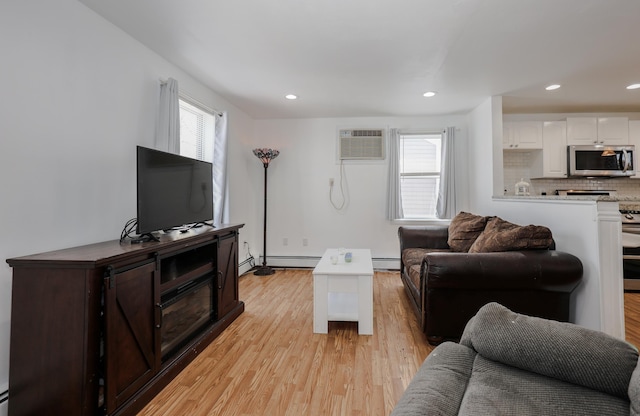 living room featuring recessed lighting, a wall unit AC, baseboard heating, and light wood finished floors