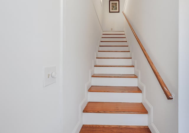 stairway featuring wood finished floors