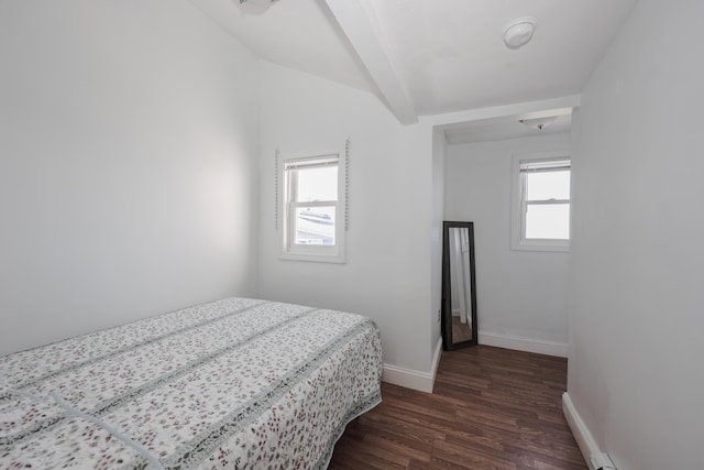 bedroom featuring baseboards, lofted ceiling with beams, and dark wood-style flooring