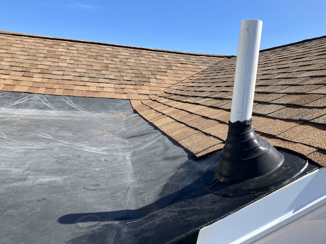 exterior details with roof with shingles