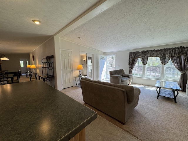 carpeted living area with a chandelier, a textured ceiling, vaulted ceiling, and ornamental molding