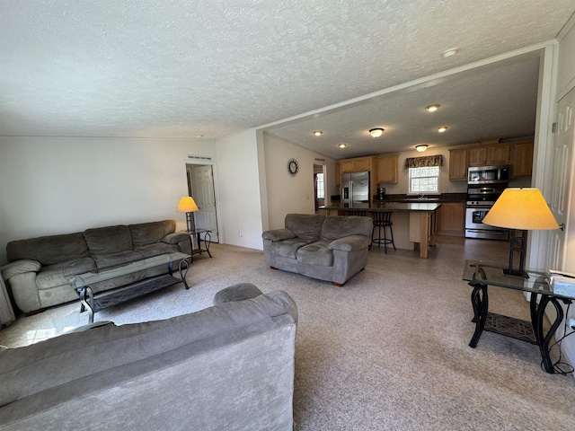 living room featuring recessed lighting, a textured ceiling, and light carpet