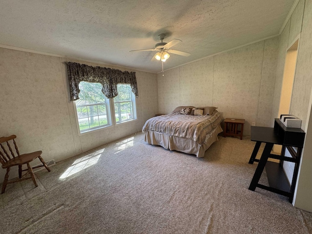 carpeted bedroom with ornamental molding, a ceiling fan, and a textured ceiling