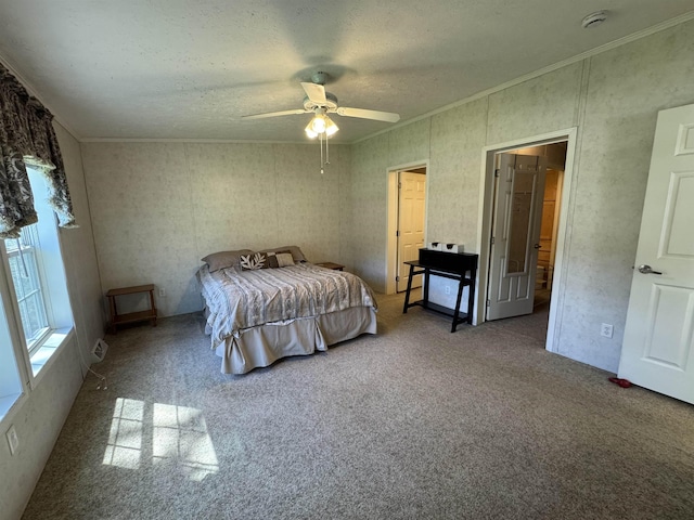 bedroom featuring crown molding, carpet flooring, a textured ceiling, and a ceiling fan