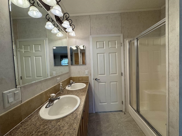 bathroom featuring a sink, tile patterned floors, and a shower stall