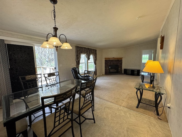 dining room with ornamental molding, a fireplace with raised hearth, and light tile patterned flooring