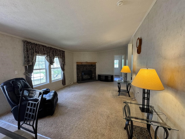 carpeted living room featuring a fireplace and a textured ceiling