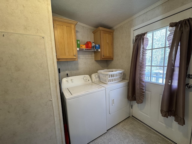 laundry area featuring crown molding, a textured ceiling, separate washer and dryer, cabinet space, and light tile patterned floors