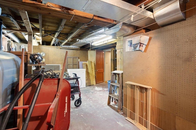 unfinished basement with fridge