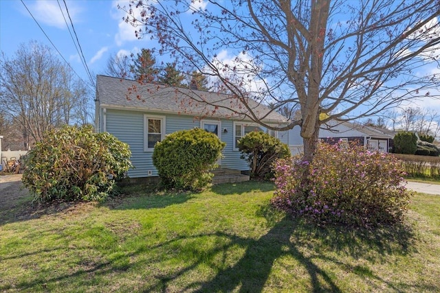 view of front of home with a chimney and a front lawn