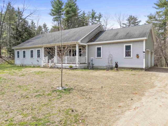 view of front of property featuring covered porch and a shingled roof