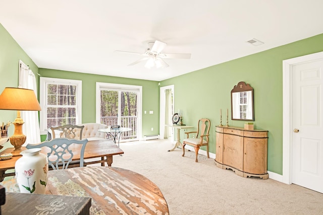 sitting room featuring ceiling fan, baseboard heating, carpet floors, baseboards, and visible vents