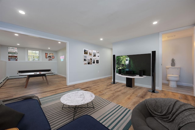 living area with recessed lighting, baseboards, visible vents, and wood finished floors