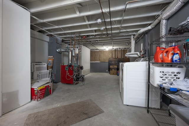 unfinished basement with a heating unit and washer / dryer