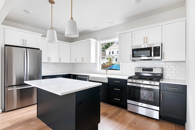 kitchen featuring light countertops, a sink, white cabinets, and stainless steel appliances