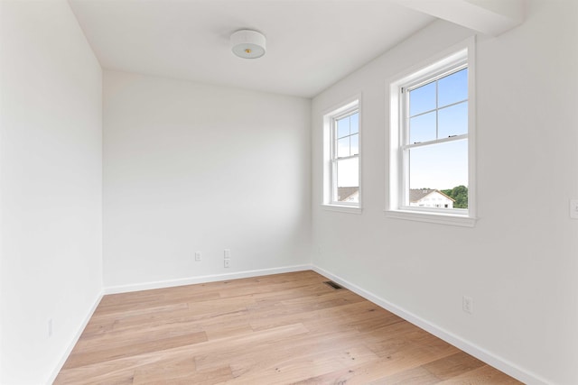 empty room featuring light wood-style floors and baseboards