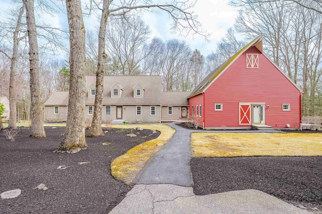 cape cod-style house featuring a barn