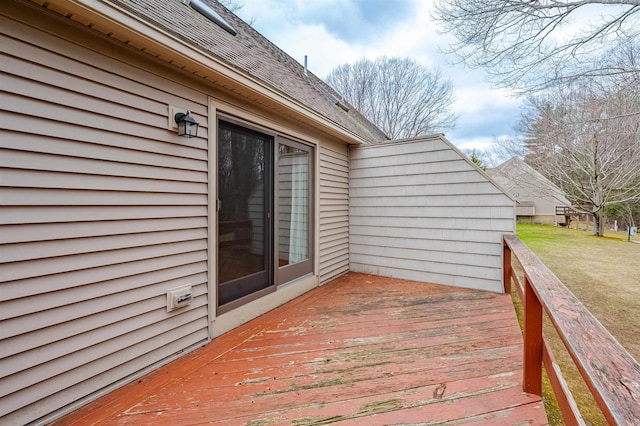wooden deck featuring a lawn
