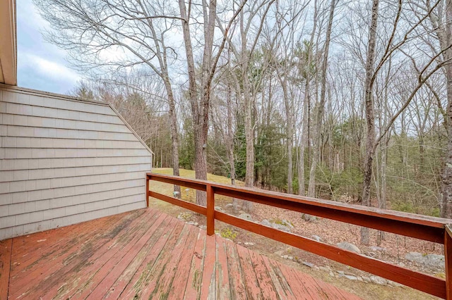 wooden terrace with a wooded view
