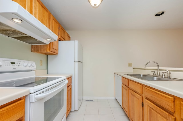 kitchen featuring white appliances, light countertops, under cabinet range hood, a sink, and light tile patterned floors