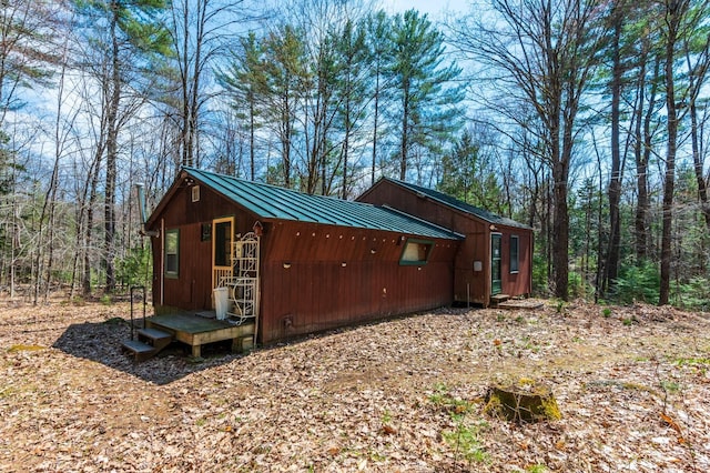 exterior space featuring a wooded view