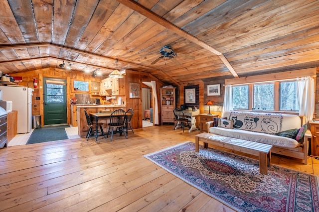 living room featuring vaulted ceiling, wood ceiling, and light wood-style flooring