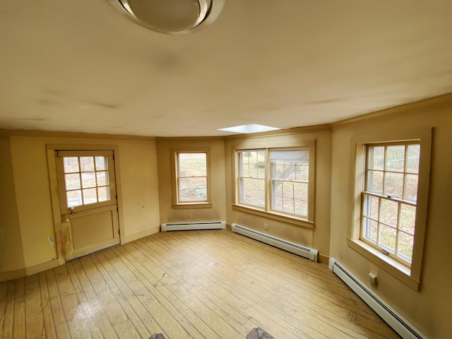 doorway to outside featuring a baseboard heating unit, ornamental molding, and light wood-style flooring