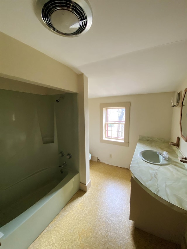 bathroom featuring vanity, baseboards, toilet, and tub / shower combination