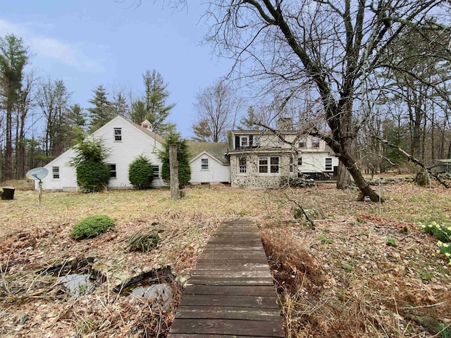 rear view of house featuring a chimney