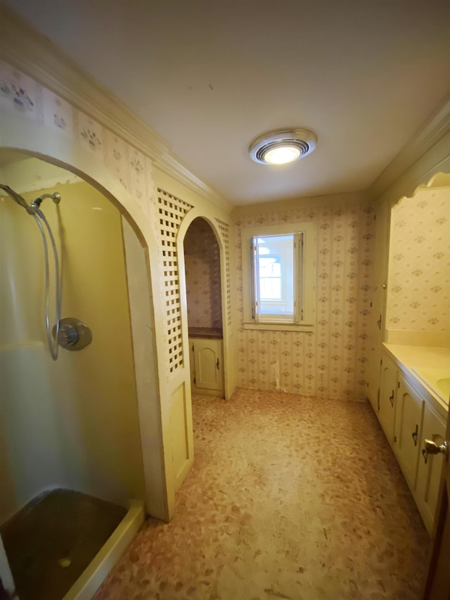corridor featuring crown molding, arched walkways, and wallpapered walls