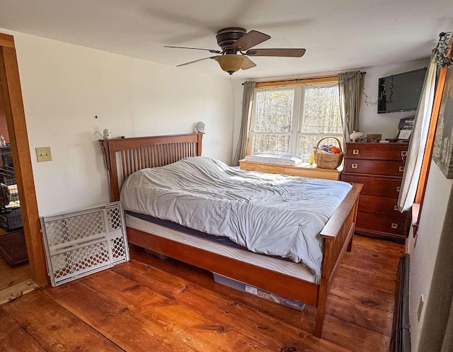 bedroom with a ceiling fan and hardwood / wood-style flooring