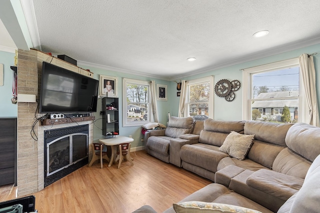 living room with ornamental molding, a textured ceiling, and wood finished floors