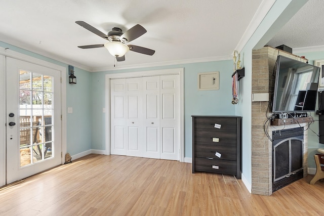 bedroom featuring a closet, ornamental molding, baseboards, access to outside, and light wood-type flooring