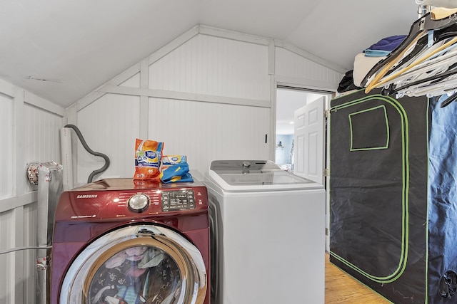 laundry room featuring laundry area, independent washer and dryer, and wood finished floors