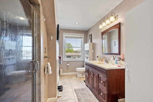 full bathroom featuring tile patterned flooring, vanity, toilet, baseboards, and a shower stall