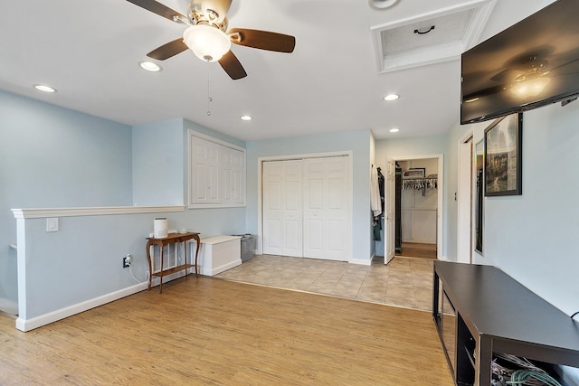 unfurnished bedroom featuring light wood-style floors, baseboards, a ceiling fan, and recessed lighting