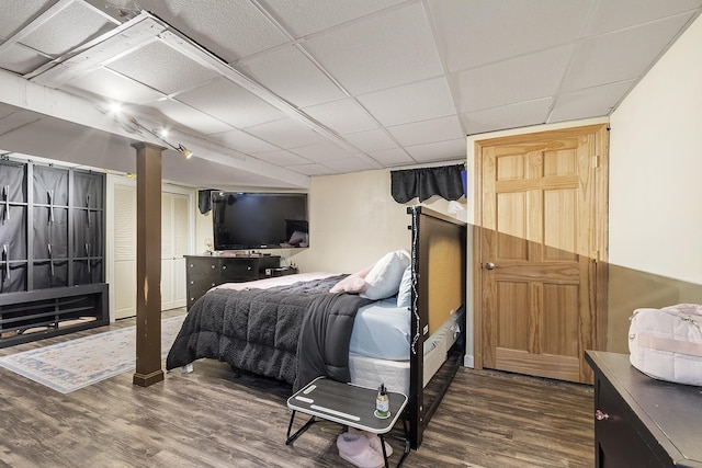 bedroom featuring a paneled ceiling and wood finished floors