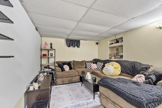 living area with a paneled ceiling