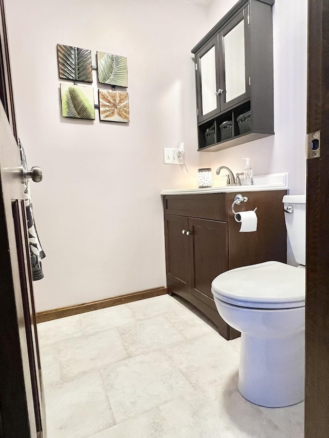 12 Nathaniel Dr, Amherst, NH 03031 - half bathroom with baseboards, vanity, and toilet