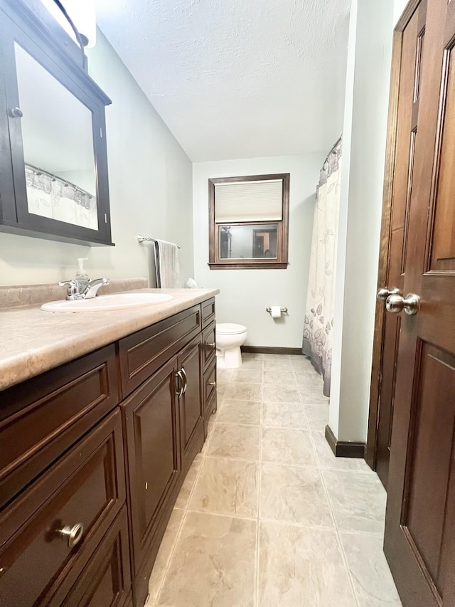 12 Nathaniel Dr, Amherst, NH 03031 - full bathroom featuring a textured ceiling, vanity, baseboards, tile patterned floors, and toilet