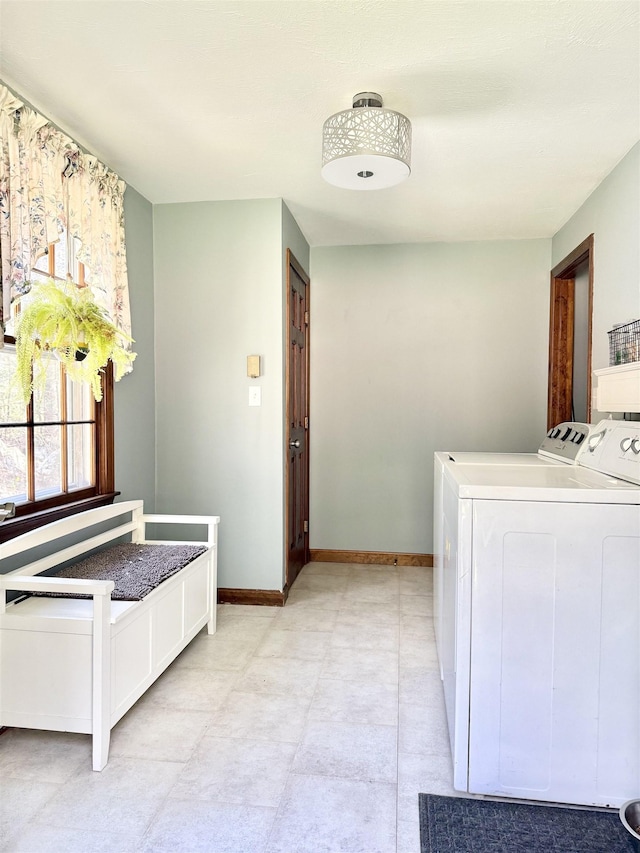 12 Nathaniel Dr, Amherst, NH 03031 - washroom with baseboards, washer and clothes dryer, and cabinet space