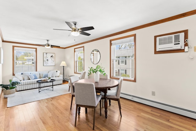 dining area featuring crown molding, a baseboard heating unit, and a healthy amount of sunlight
