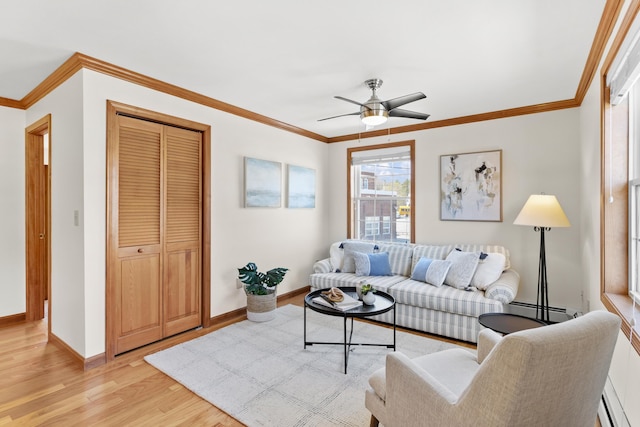 living room with baseboards, ornamental molding, ceiling fan, and light wood-type flooring