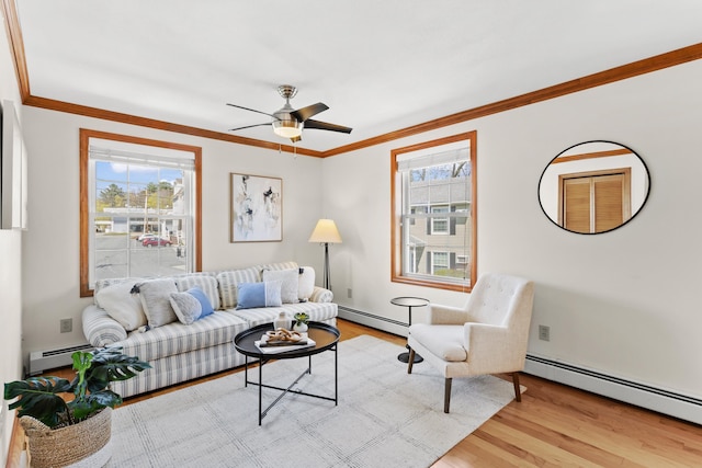 living room with baseboard heating, wood finished floors, and a wealth of natural light