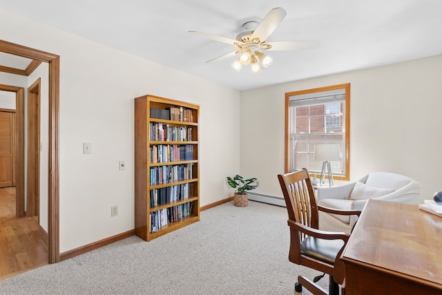 office area featuring carpet floors, a ceiling fan, and baseboards