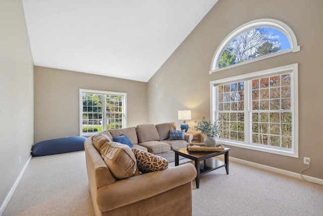 carpeted living room with baseboards and a towering ceiling