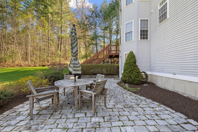 view of patio / terrace featuring stairs and outdoor dining space