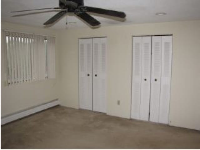 131 English Village Rd Unit 204, Manchester, NH 03102 - unfurnished bedroom featuring carpet floors, a ceiling fan, and multiple closets