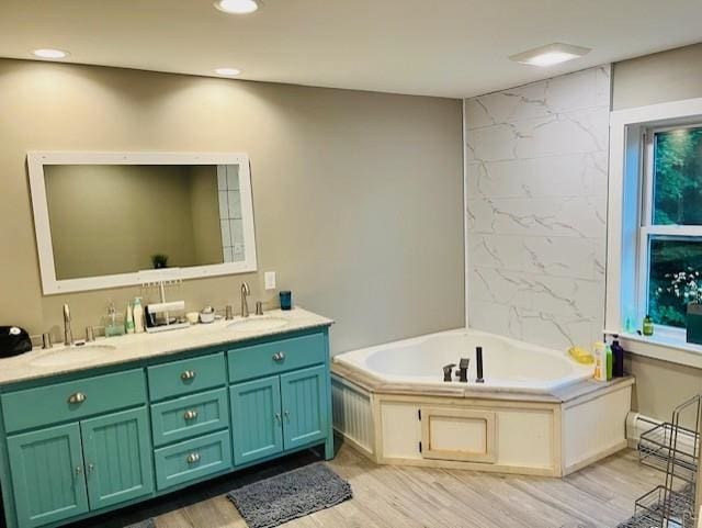 bathroom featuring double vanity, a sink, and wood finished floors