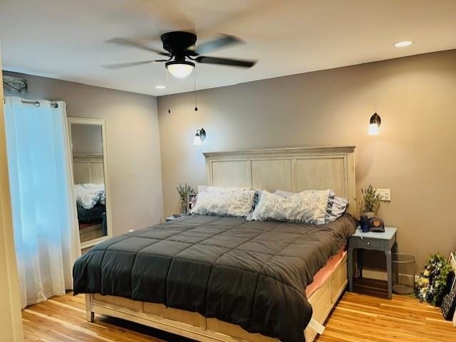 bedroom with a ceiling fan, recessed lighting, light wood finished floors, and a closet